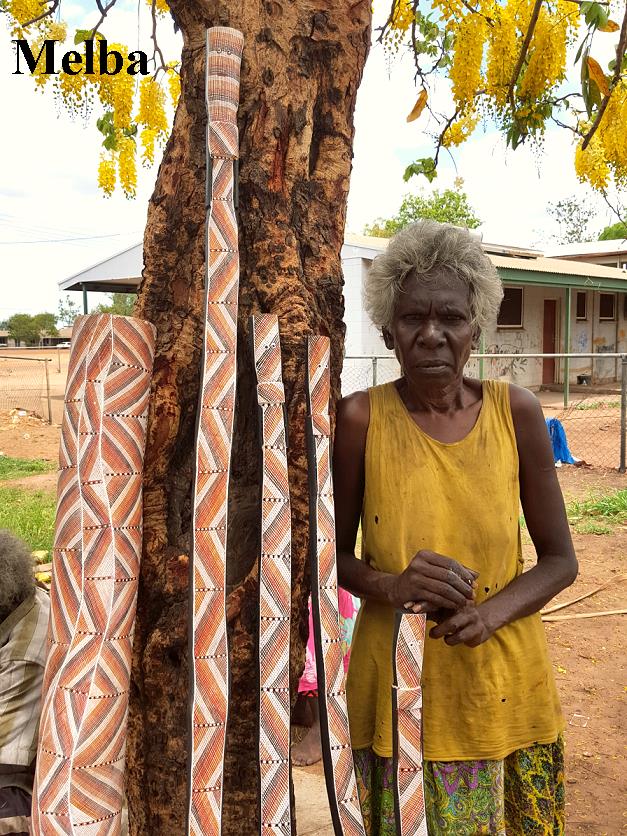 photo of Melba Gunjarrwanga holding her mimi spirit poles 